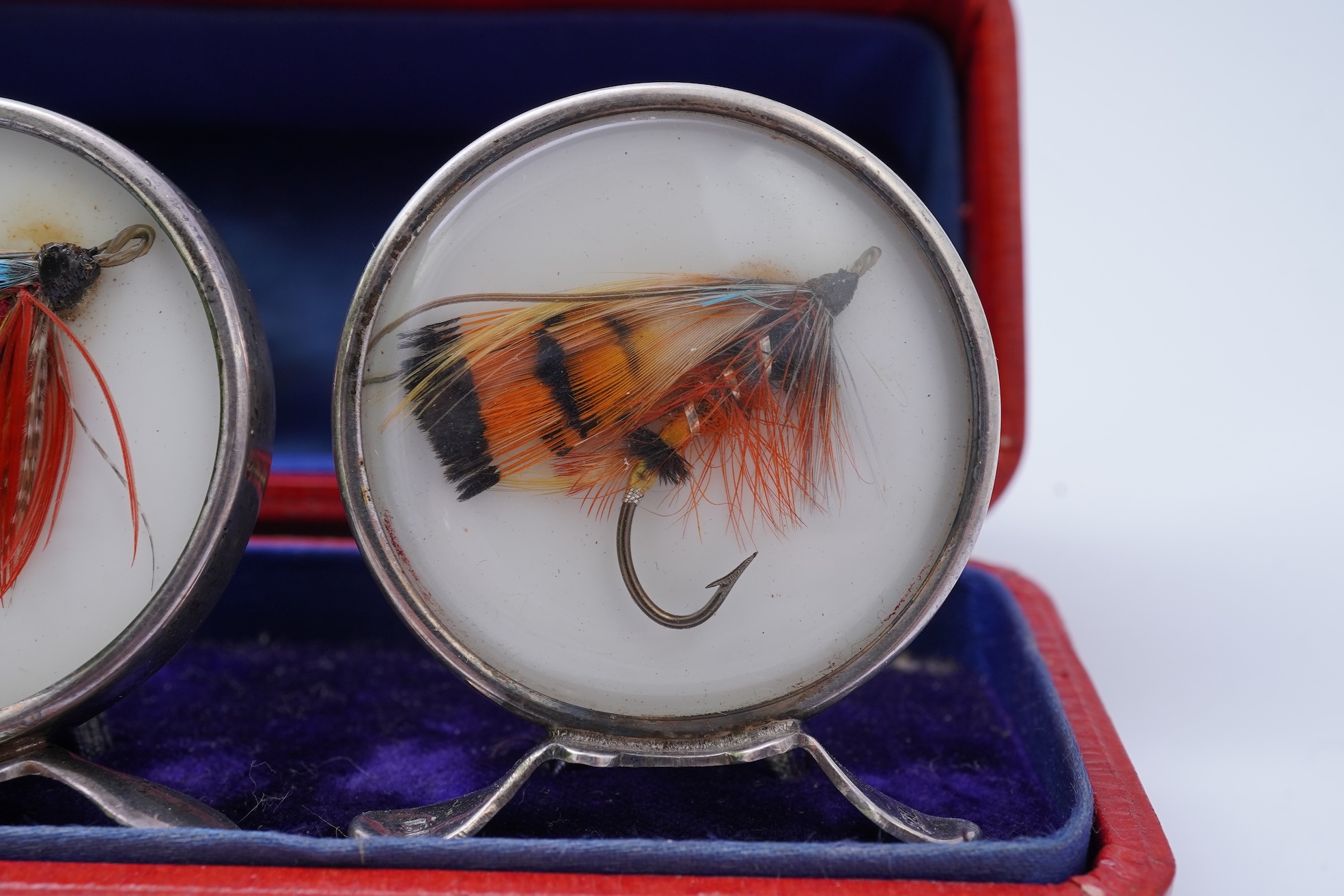 A set of four early 20th century silver mounted fishing related novelty menu holders, by Grey & Co, housed in a red leather case with gilt initials RV